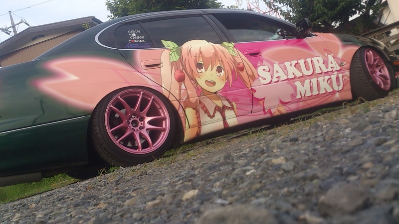 car character_name cherry_hair_ornament collared_shirt food-themed_hair_ornament hair_ornament hatsune_miku itasha lexus lexus_gs long_hair mikawa_ayumu motor_vehicle no_humans open_mouth outdoors pebble photo_(medium) pink_hair sakura_miku sekai_no_owari shirt toyota toyota_aristo twintails unconventional_media utility_pole vehicle_focus vocaloid