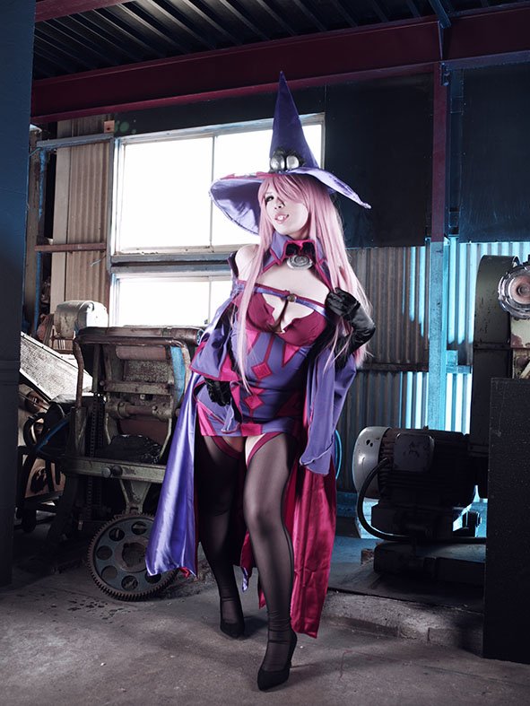 1girl 2018 arc_system_works arm_at_side black_sclera black_shoes blazblue breasts cape cleavage colored_sclera commentary contrapposto cosplay cosplay_photo day detached_sleeves dress female_focus full_body gloves grin hair_over_one_eye hand_on_own_chest hat high_heels indoors japanese_(nationality) konoe_a._mercury konoe_a._mercury_(cosplay) large_breasts long_hair long_sleeves looking_at_viewer mature_female one_eye_covered orange_eyes photo_(medium) pink_hair pink_lips purple_dress purple_gloves purple_hat purple_thighhighs real_life red_cape shoes short_dress sleeveless sleeveless_dress smile solo standing strappy_heels sunlight takana_mikoko thighhighs very_long_hair wavy_hair wide_sleeves witch witch_hat