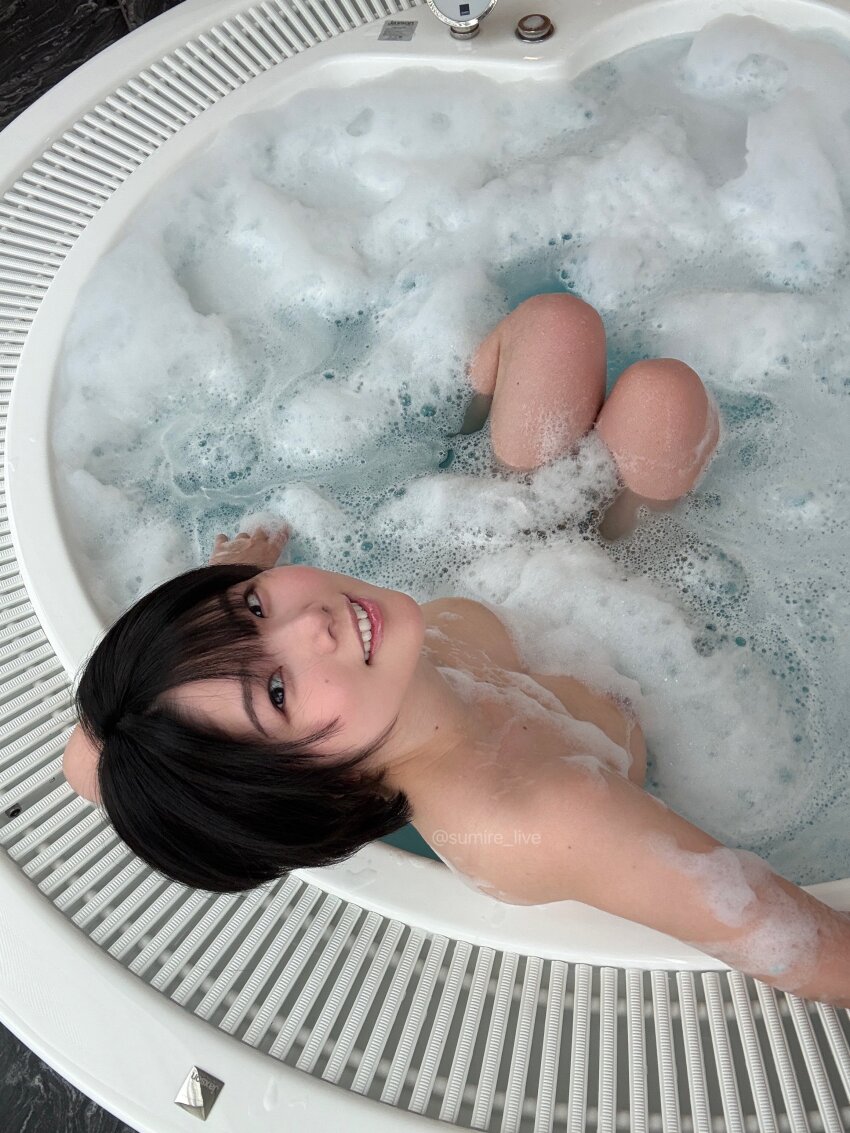1girl absurdres asian bath bathing bathtub black_hair breasts highres indoors japanese_(nationality) looking_at_viewer nude partially_submerged photo_(medium) real_life short_hair smile soap_bubbles solo sumire_live teeth twitter_username water